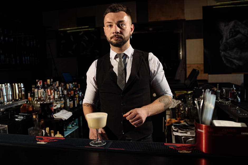 Bartender serving drinks at a lounge bar counter