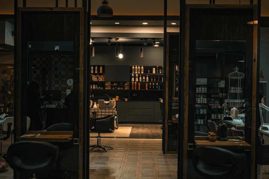 Interior de una peluquería con sillas, espejos y recepción