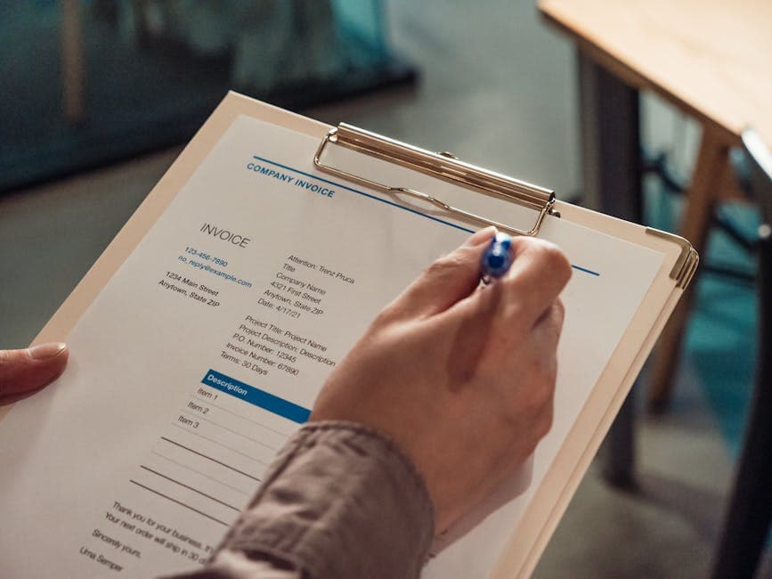 Business invoice document on a desk with a laptop