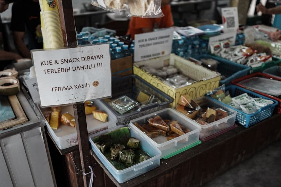 Colourful Indonesian snacks and packaged goods on a traditional market shelf