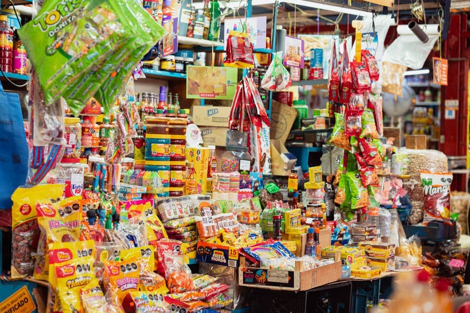 Colorful corner-store stall in Mexico City stocked with snacks and goods