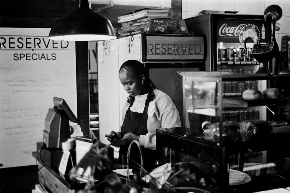 South African shop owner using a free POS app on a phone during loadshedding