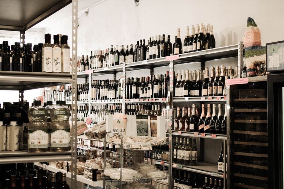 Shop owner managing inventory stock on shelves