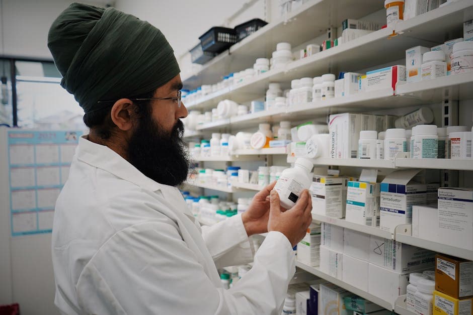 Pharmacist managing medicine stock and expiry dates on shelves