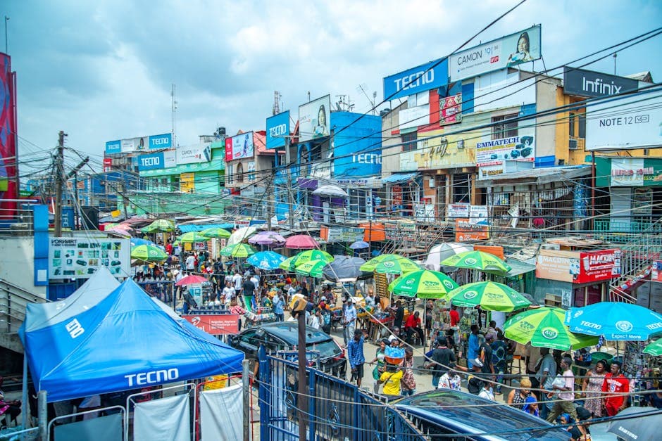 Nigerian small business owner using a smartphone at the market